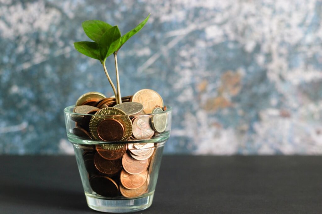 Coins and a growth chart illustrating dollar-cost averaging versus lump-sum investing