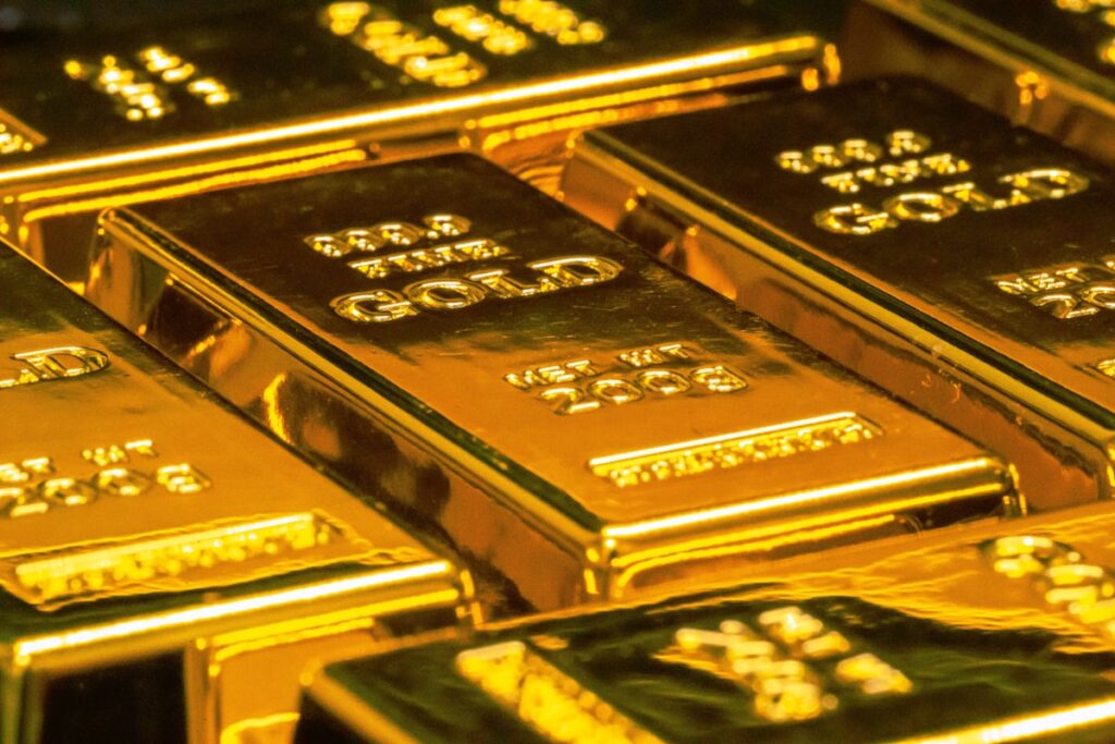 Gold Reaches $2,420 as Central Bank Buying and Geopolitical Tensions Support Safe Haven Demand Gold bars representing safe haven demand and central bank buying