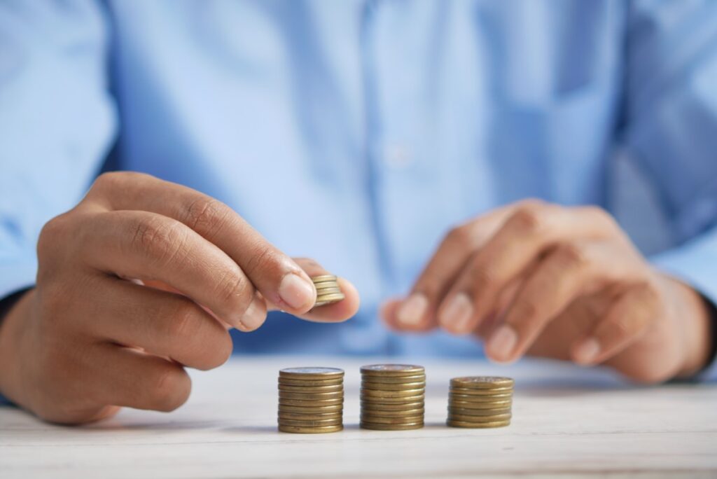 Stacks of coins growing over time representing compound interest